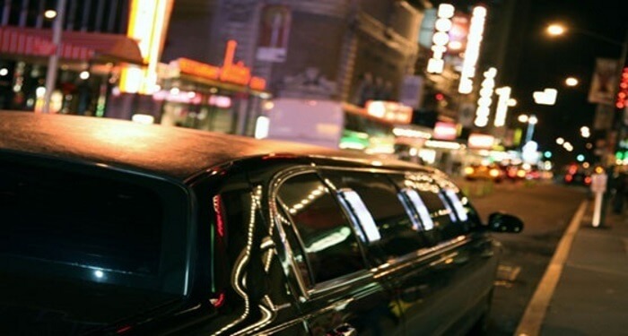 limo driving through the city night